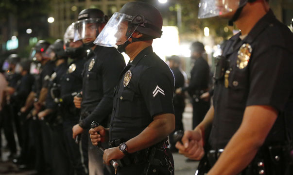 Police corral protesters before making mass arrests in Los Angeles, following Monday's grand jury decision in the shooting of Brown